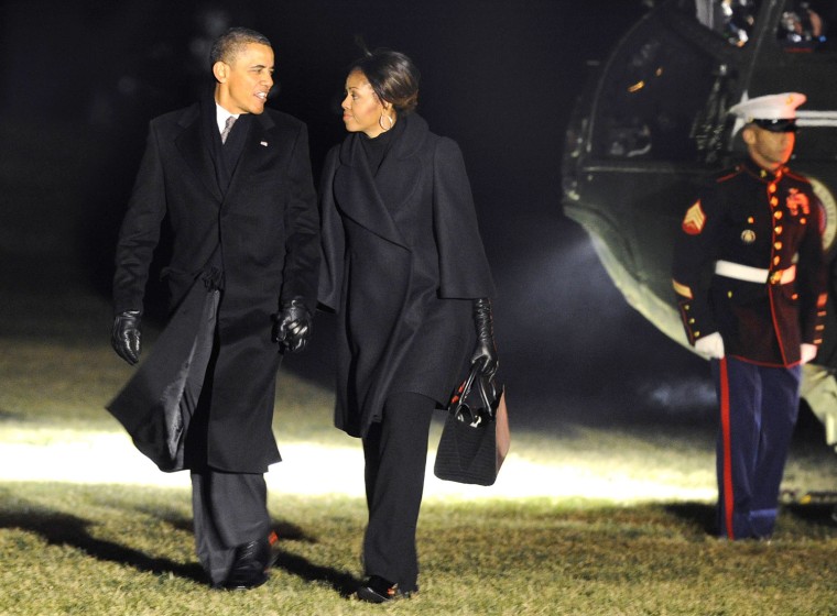 Image: U.S. President Barack Obama and first lady Michelle Obama return to Washington from Mandela memorial service